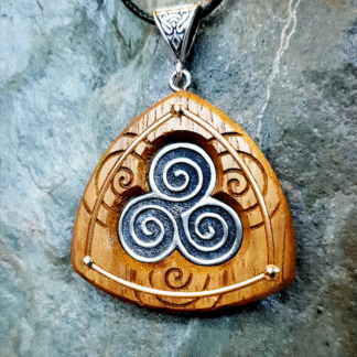 Classic Handmade Triskele Necklace in fine pewter on Iroko with background of spirals